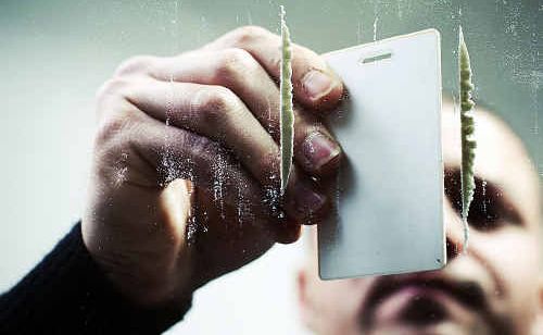 A man preparing cocaine. A man preparing cocaine.